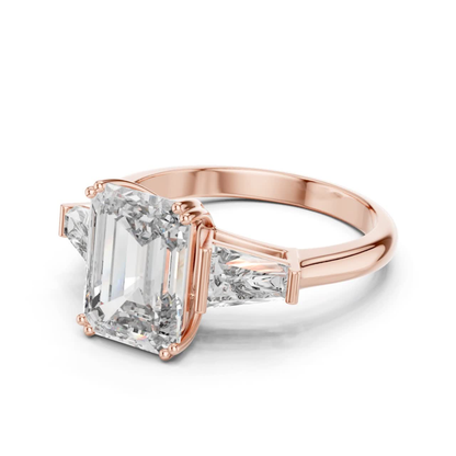 Angled view emerald cut diamond ring
Rose gold emerald cut baguette diamond ring
Emerald cut diamond with tapered baguette stones
Three stone emerald cut diamond ring
Four prong emerald cut diamond ring
Rose gold diamond ring angled profile
Emerald cut center stone with baguette sides
Classic emerald cut diamond ring in rose gold
Angled rose gold diamond ring design
Emerald cut three stone ring side angle