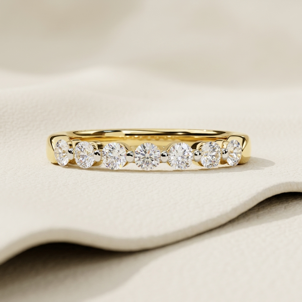 Yellow gold band with graduated round diamond row
Brilliant round diamonds aligned across an open gallery setting
Elegant gold band featuring seven sparkling diamond accents
Graduated diamonds arranged in a balanced curved sequence
Polished yellow gold band showcasing prominent round cut stones
Refined diamond band with larger center stones and tapered sides
Fine jewelry band featuring symmetrical brilliant diamond placement
Radiant round diamonds displayed within a sleek open gold frame
Contemporary gold b