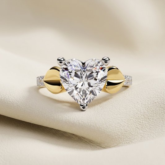 Yellow gold heart cut solitaire diamond bypass engagement ring
Elegant heart shaped diamond ring with bypass band design
Luxury yellow gold heart solitaire engagement ring with pavé shoulders
Fine jewelry heart cut diamond bypass ring in yellow gold
Contemporary heart shaped solitaire ring with polished gold bypass setting
Premium heart diamond engagement ring with pavé accent band
Designer heart cut solitaire bypass diamond ring close up
Romantic yellow gold heart diamond ring with modern bypass style
Styl