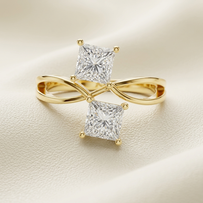 Elegant infinity ring with two princess cut diamonds
Stylish gold ring with twisted band and diamond tips
Modern dual diamond ring with crossover design
Fine jewelry piece with infinity-inspired structure
Contemporary ring with balanced square diamonds
Minimal gold ring with sleek twist detailing
Premium open style ring with geometric diamonds
Sophisticated infinity band with sparkling stones
Designer gold ring with unique dual setting
Close-up of luxury ring with twin diamond brilliance