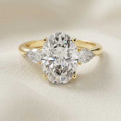 Oval three stone diamond ring in yellow gold.
Yellow gold oval diamond engagement ring.
Oval diamond ring with pear side stones.
Three stone oval diamond ring.
Oval cut diamond ring in gold.
Elegant oval engagement ring.
Oval diamond ring with tapered side stones.
Classic three stone diamond ring.
Luxury oval diamond ring.
Oval solitaire ring with pear diamonds.