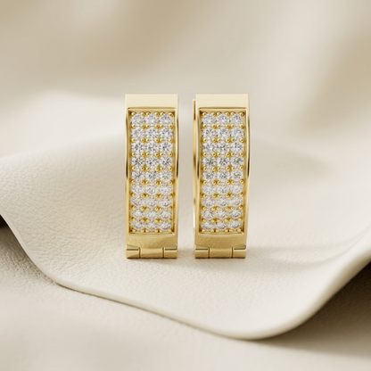 Yellow gold hoop earrings featuring multiple rows of brilliant pavé-set diamonds.
Elegant gold diamond hoop earrings with a sleek rectangular silhouette.
Luxury yellow gold earrings adorned with sparkling round pavé diamonds.
Contemporary diamond hoop earrings crafted in polished yellow gold.
Fine jewelry gold hoops showcasing brilliant pavé diamond detailing.
Premium yellow gold earrings with a modern diamond-studded design.
Stylish gold hoop earrings featuring dazzling diamonds for everyday elegance.
Hand
