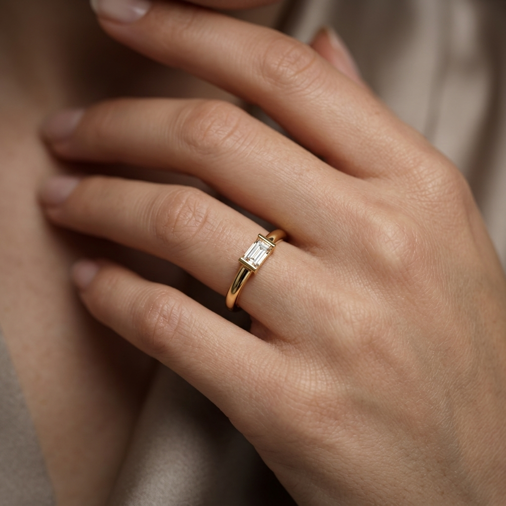 Emerald cut diamond ring on woman's hand
Yellow gold emerald cut solitaire ring on finger
Minimalist emerald cut diamond ring close-up
Elegant emerald cut engagement ring lifestyle image
Fine jewelry emerald cut diamond ring for women
Modern yellow gold emerald cut solitaire ring
Delicate emerald cut diamond ring on hand
Premium emerald cut diamond ring lifestyle photography
Hand wearing minimalist emerald cut engagement ring
Luxury emerald cut diamond solitaire ring