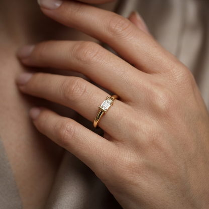 Emerald cut diamond ring on woman's hand
Yellow gold emerald cut solitaire ring on finger
Minimalist emerald cut diamond ring close-up
Elegant emerald cut engagement ring lifestyle image
Fine jewelry emerald cut diamond ring for women
Modern yellow gold emerald cut solitaire ring
Delicate emerald cut diamond ring on hand
Premium emerald cut diamond ring lifestyle photography
Hand wearing minimalist emerald cut engagement ring
Luxury emerald cut diamond solitaire ring