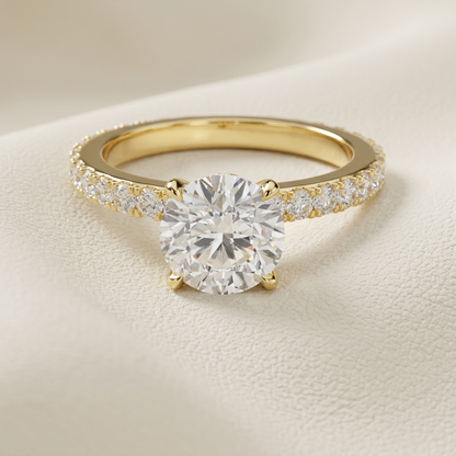 Yellow gold solitaire ring with a brilliant round center stone
Elegant round diamond ring with a sparkling pavé gold band
Luxury gold engagement ring featuring a large round center diamond
Classic solitaire diamond ring with shimmering band accents
Brilliant round cut stone set on an elegant yellow gold ring
Timeless gold engagement ring with a dazzling round centerpiece
Fine jewelry ring featuring a round stone and pavé set band
Sophisticated yellow gold ring with brilliant solitaire design
Glamorous round
