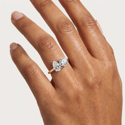 Two stone pear and round diamond ring on hand
Pear and round diamond ring worn on finger
Close up of two stone diamond ring on hand
Toi et Moi pear and round diamond ring on hand
Luxury pear and round diamond ring on finger
Elegant two stone diamond ring with gold band
Fine jewelry pear and round diamond ring worn by model
Modern two stone diamond ring on hand
Hand wearing pear and round cut diamond ring
Contemporary pear and round diamond ring lifestyle view